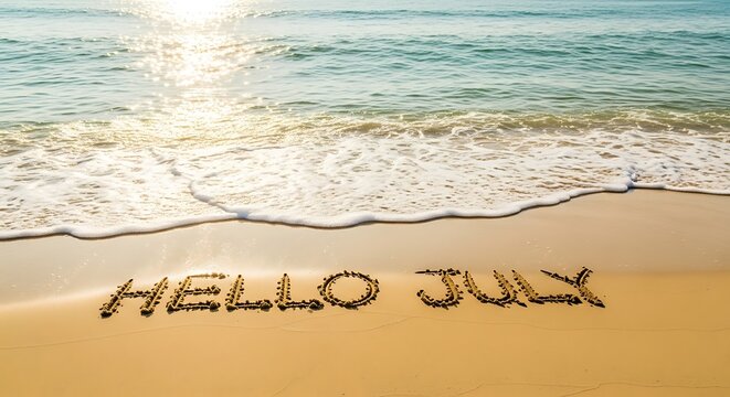 Hello july written in sand on a beach at sunrise