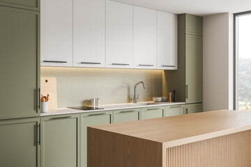 Naklejka premium Modern kitchen interior with green cabinets, white cupboards, wood island, soft lighting and tiled backsplash in contemporary home setting. 3D Rendering