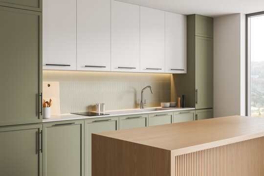 Modern kitchen interior with green cabinets, white cupboards, wood island, soft lighting and tiled backsplash in contemporary home setting. 3D Rendering