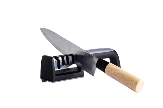 isolated image, transparent background. Kitchen knife resting on a black knife sharpener with a wooden handle, isolated on a white background for culinary use and food preparation