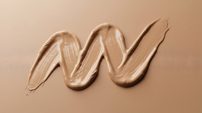 A smooth beige liquid foundation makeup smear in a wavy zig zag shape