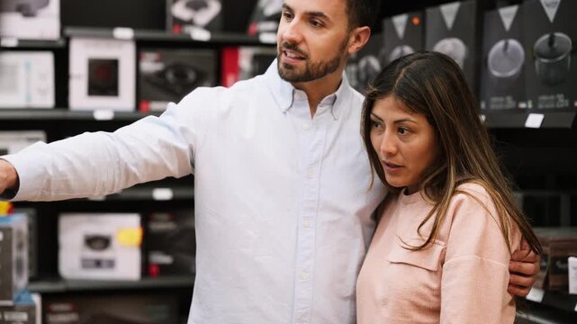 Couple choosing electronics together in a retail store