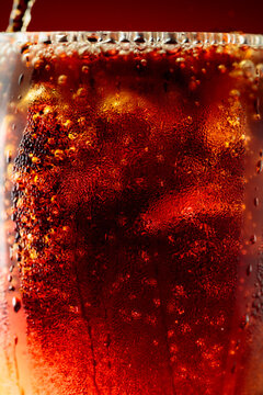 Fizz sparkling cola bubbly soda pop with ice cubes.