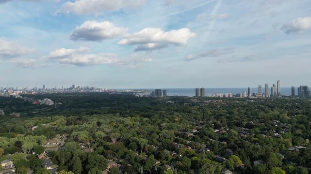Aerial over the Kingsway in Toronto, Ontario, Canada just south of Bloor Street West. Panning shot right, looking towards the downtown core Toronto skyline, Humber River, Mimico and Lake Ontario.