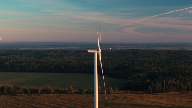 Wind power generation in beautiful rural landscape at golden hour
