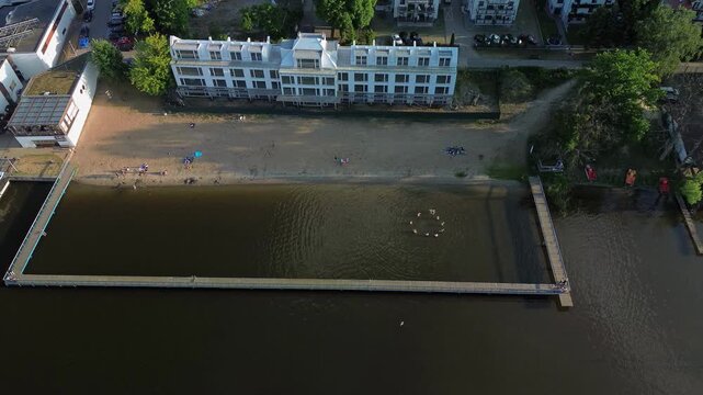 Aerial View of Beach, Pier and People Playing Ball in the Water in Iława on Lake Jeziorak &ndash; 4K ProRes