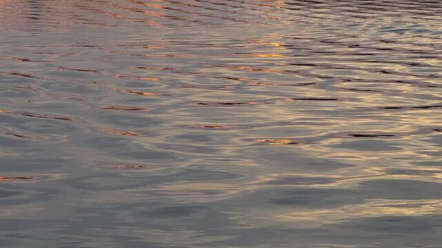 sunset dusk reflection on lake waves abstract water pattern wake texture background video