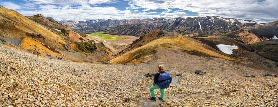 Hiker on the Laugavegur trekking trail, Laugavegur trekking trail, Dramatic volcanic landscape, Colourful erosion landscape with mountains, Lava field, Landmannalaugar, Fjallabak nature reserve, Su&eth;urland, Iceland
