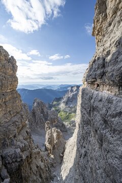 View from the Bocca degli Armi gap, mountaineers on a rock band on the Via Ferrata Bocciere Centrale via ferrata, Brenta Mountains, Brenta-Adamello Natural Park, Trentino, Italy