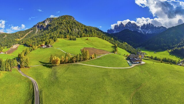 Farm and alpine meadows, in the background the peaks of the Geisler group, panoramic shot, drone shot, Sankt Magdalena, Villn&ouml;&szlig;tal, Dolomites, Autonomous Province of Bolzano, South Tyrol, Italy