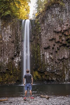Man standing in front of a waterfall, Abiqua Falls, Oregon, USA