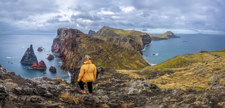 Hiker, coastal landscape, cliffs and sea, Miradouro da Ponta do Rosto, rugged coastline with rock formations, Cape Ponta de S&atilde;o Louren&ccedil;o, Madeira, Portugal
