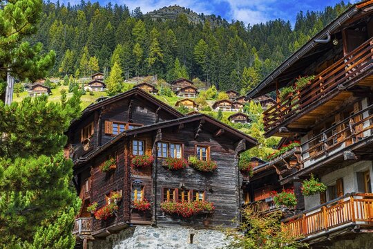 Wooden houses decorated with flowers in the historic village centre, Grimentz, Val d'Anniviers, Valais Alps, Canton Valais, Switzerland