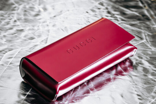 Nice, France - March 1, 2026: Red Gucci leather eyeglasses case photographed in a studio setting, featuring embossed Gucci branding, smooth leather finish and luxury accessory craftsmanship