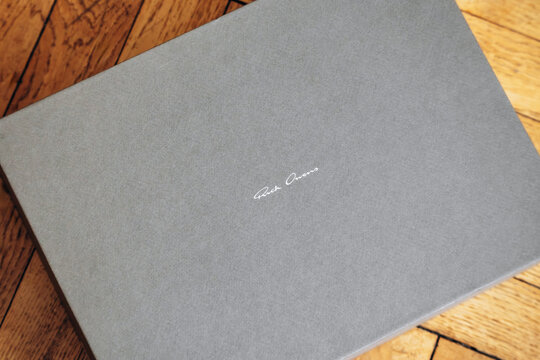 Nice, France - March 1, 2026: Rick Owens branded luxury footwear box displayed on a wooden parquet floor, highlighting designer packaging and contemporary fashion branding