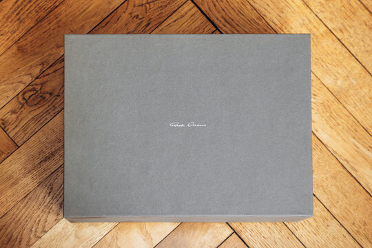Nice, France - March 1, 2026: Rick Owens branded luxury footwear box displayed on a wooden parquet floor, highlighting designer packaging and contemporary fashion branding