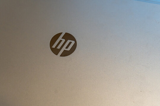 Warsaw, Poland - Jan 11, 2026: Close-up of HP logo on metallic laptop surface, showcasing technology and design in modern computing environment