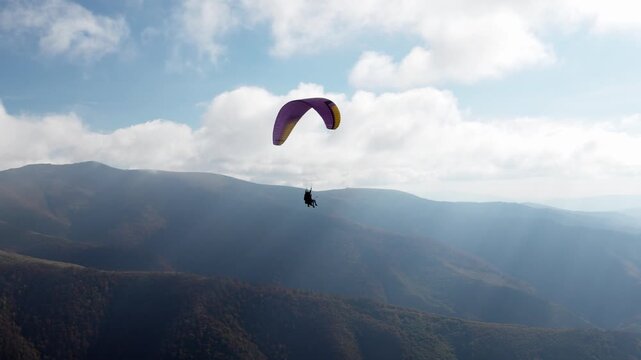 Paragliding active sport against giant mountains in highland