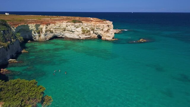 Aerial view of Faraglioni di Sant'Andrea sea stacks in Puglia, Puglia, Italy