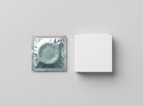 A sterile unopened condom wrapper alongside its accompanying minimalist cardboard packaging, showcasing potential health, prevention, and personal care themes prominently arranged for clear