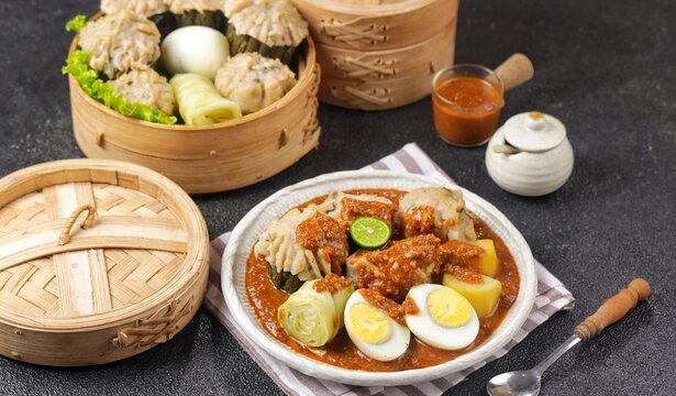 Siomay Bandung. Fish cake dumplings with potato, egg, and cabbage roll served with peanut, chili, sweet soy sauces and lime