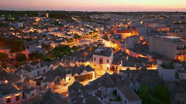 Aerial night view of the illuminated Trulli in Alberobello, Puglia, Italy