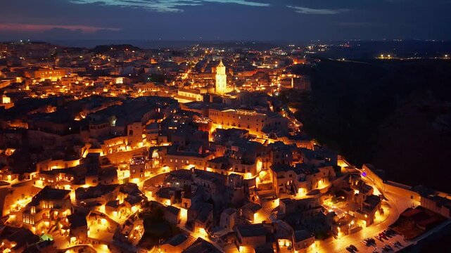 Aerial night view of the illuminated Sassi di Matera, Basilicata, Italy