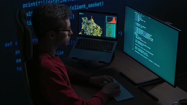 Data scientist works at night on artificial intelligence project, types on keyboard, screens displaying scripts and graphs, projection with running code on a wall behind. 
