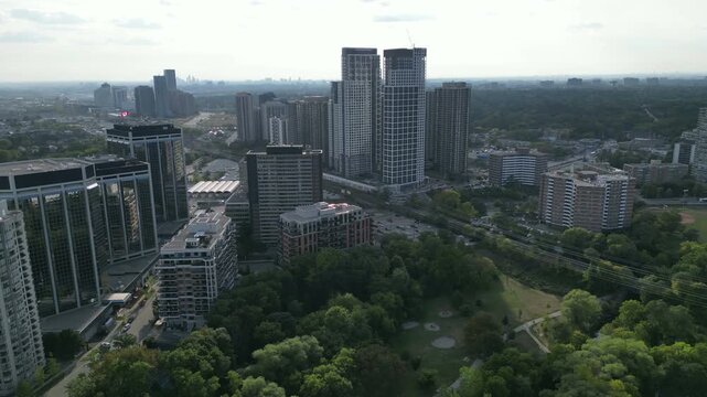 Aerial over Bloor Street West in Kingsway, Toronto, Ontario, Canada. Panning left, skyline of high-rises around Islington Station, overlooking the Islington City-Centre West neighborhood. 2022.