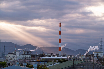 Obraz premium Japan industrial factory area with sunset sky and sun light beam background view in Japan.
