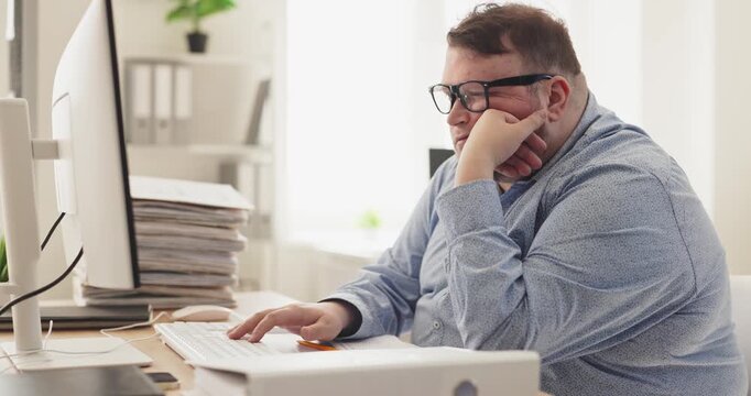 Man office accountant with fatigue at computer. Paperwork piles and a tight deadline surround his desk, leaving him tired and yawning. Concept illustrates workplace fatigue and burnout.