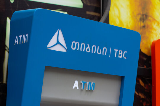 Tbilisi, Georgia - May 12, 2026: Close up photo. Blue ATM payment terminal machine with white TBC Bank logo. GEL, lari bill. Concept of salary, plastic card, cash money, loan, debt, pay tax, credit