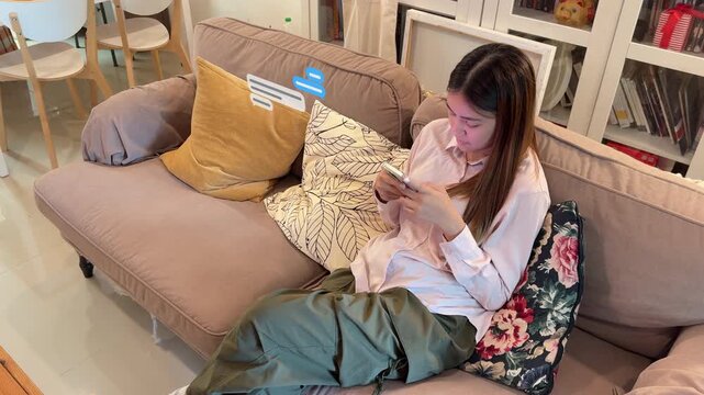 Wide and high angle 4K footage of an Asian female buyer using a credit card and smartphone with 3D perspective text bubble animations.