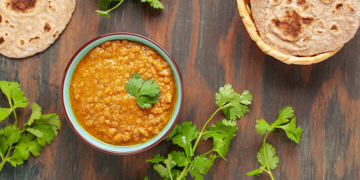 Indian dal food (Masoor Dal or Dal Tadka Curry) and homemade Flatbread Chapati. Traditional Indian soup lentils. Indian Top view