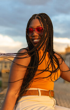 Woman smiling enjoying a blissful sunset moment outdoors
