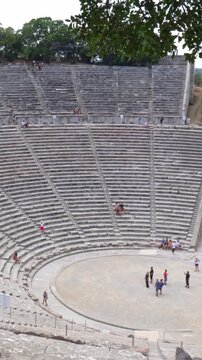 Young woman enjoying the ancient Theatre of Epidaurus in Greece