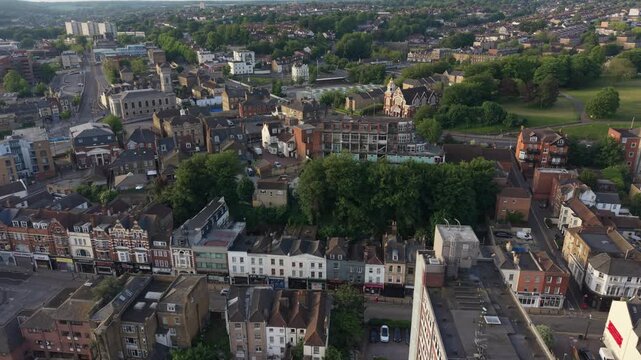 Chatham old town in Kent, UK. Aerial view at sunrise above high street and the river Medway.  High rise apartment building and residential houses. Flying towards church. English town by the river.