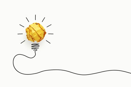 Crumpled yellow paper ball as a light bulb with drawn black line