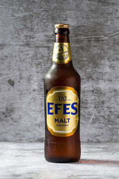 Antalya, Turkey - June 13, 2026: Efes Malt beer bottle isolated on concrete background, editorial beverage photography