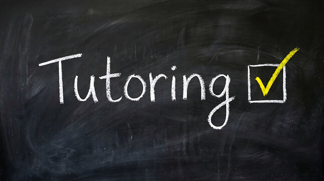 Tutoring handwritten word on black chalkboard with a yellow check mark