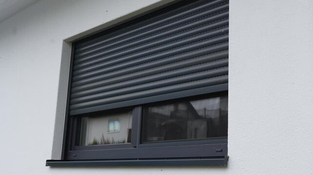Process of closing protective roller shutters on window