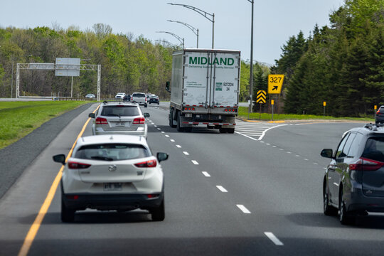 Gaspesie, Canada, 30 May 2026 : A Midland semi-truck drives on a multi-lane highway alongside passenger vehicles, approaching an exit.