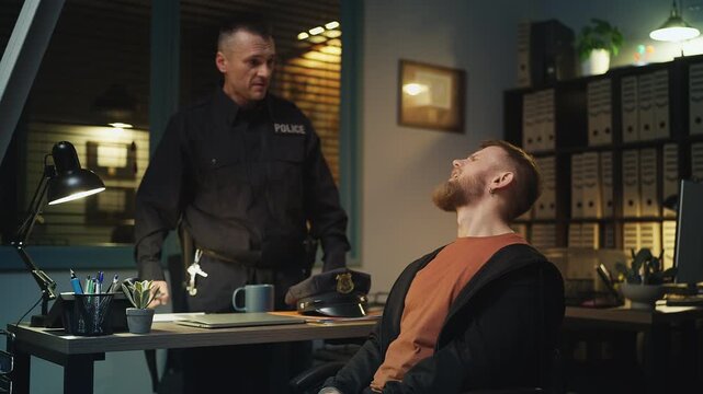Strict police officer interrogating a dishonest suspect and pressing charges