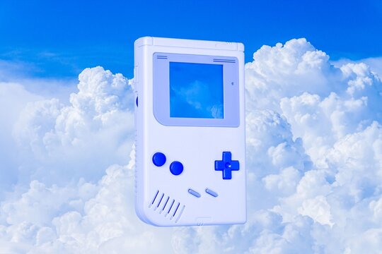 Y2K aesthetic background with retro handheld gaming console in clouds vector
