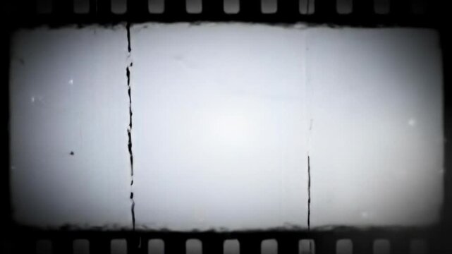 Black and white vintage film texture video, evolving with flickering, dynamic light leaks, dust, scratches, and a subtle dolly zoom. An irregular film frame border surrounds, clearing to a blurred