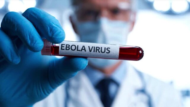 Ebola Virus Sample: A gloved hand holds a test tube containing a blood sample labeled Ebola Virus, representing a scientific investigation into infectious diseases and medical research.