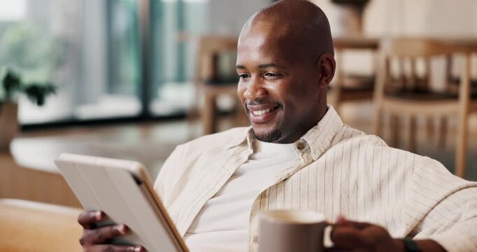 Smile, black man and relax in home with tablet, social media and browsing website in lounge. Male person, coffee and laughing in living room with digital app, streaming movies and funny meme on couch
