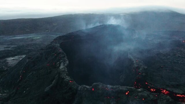 Aerial Drone View of Geldingadalir Volcano Crater with Glowing Lava Embers and Smoke at Night, Iceland