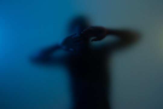 Man behind frost glass showing anonymity trap concept. 