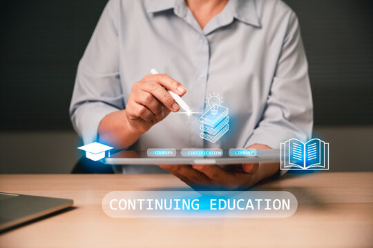 Continuing education concept, business professional using tablet and stylus to access virtual courses, certification, library icons, and e learning dashboard in modern office workspace.